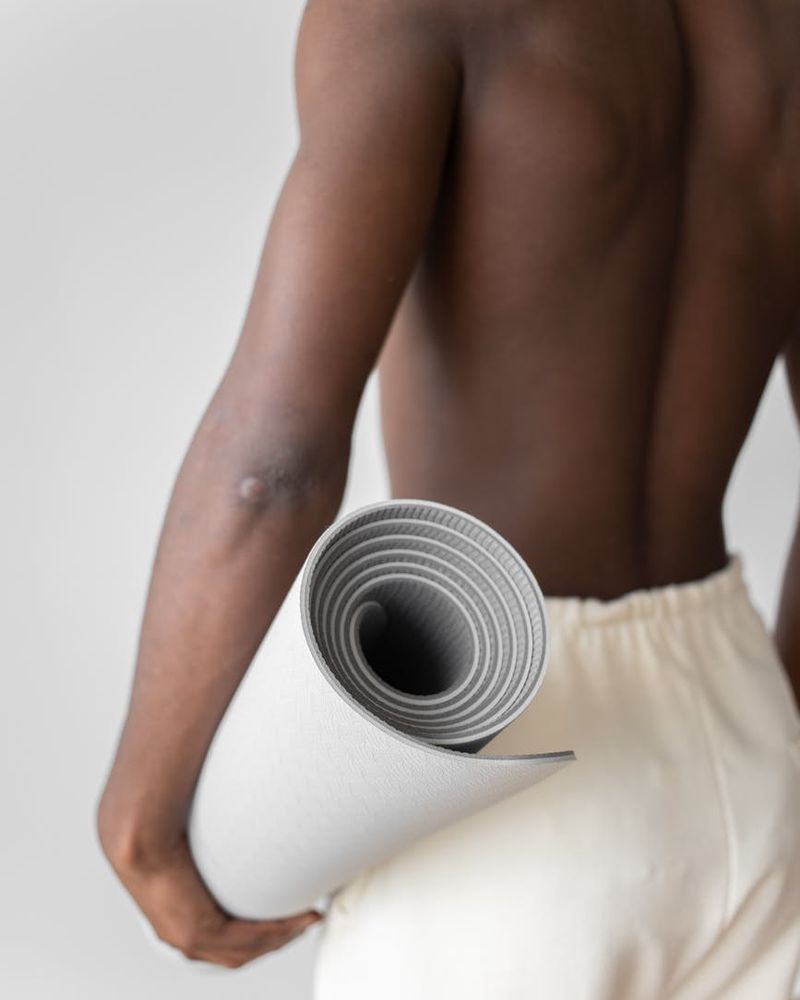A minimalist and serene yoga studio interior with soft lighting and plants.