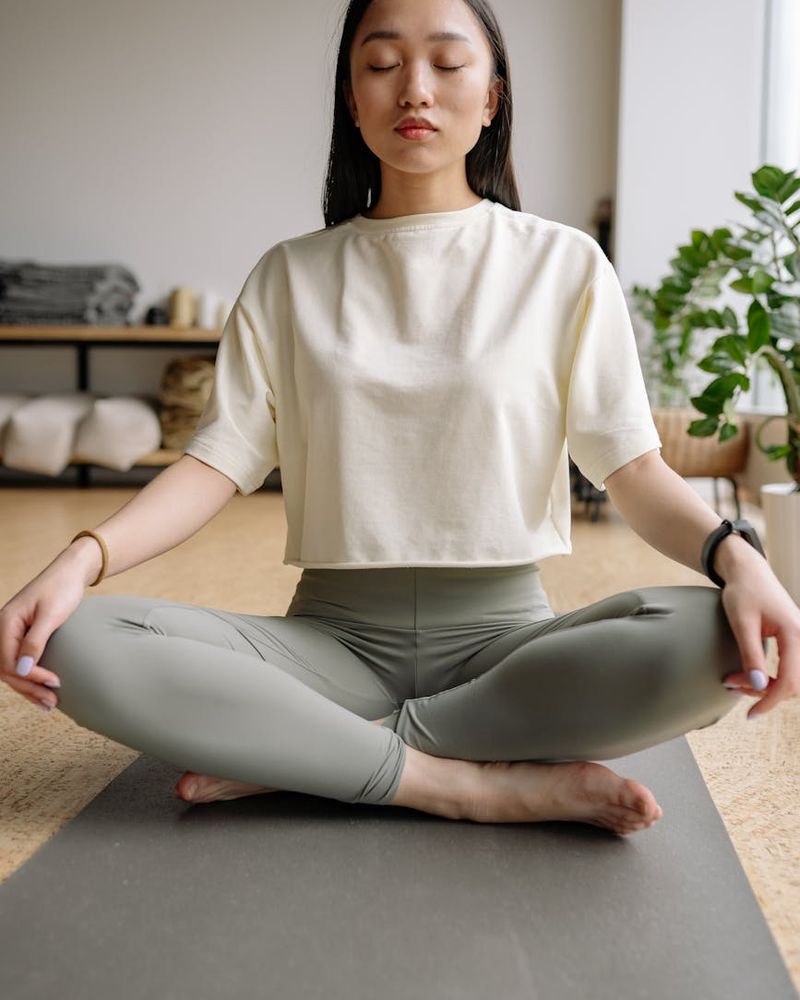 A person sitting in a meditative yoga pose, symbolizing inner balance and peace.